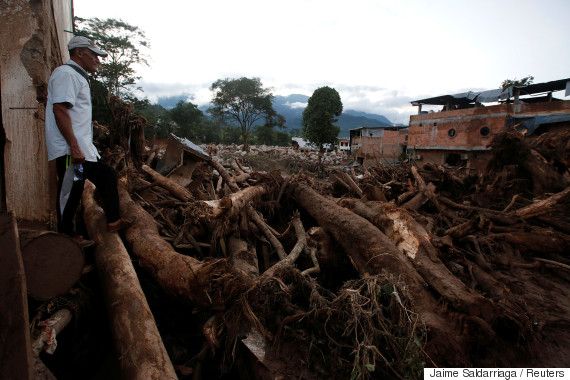 A man looks at a destroyed area after heavy rains caused several rivers to overflow, pushing sediment and rocks into buildings and roads in Mocoa